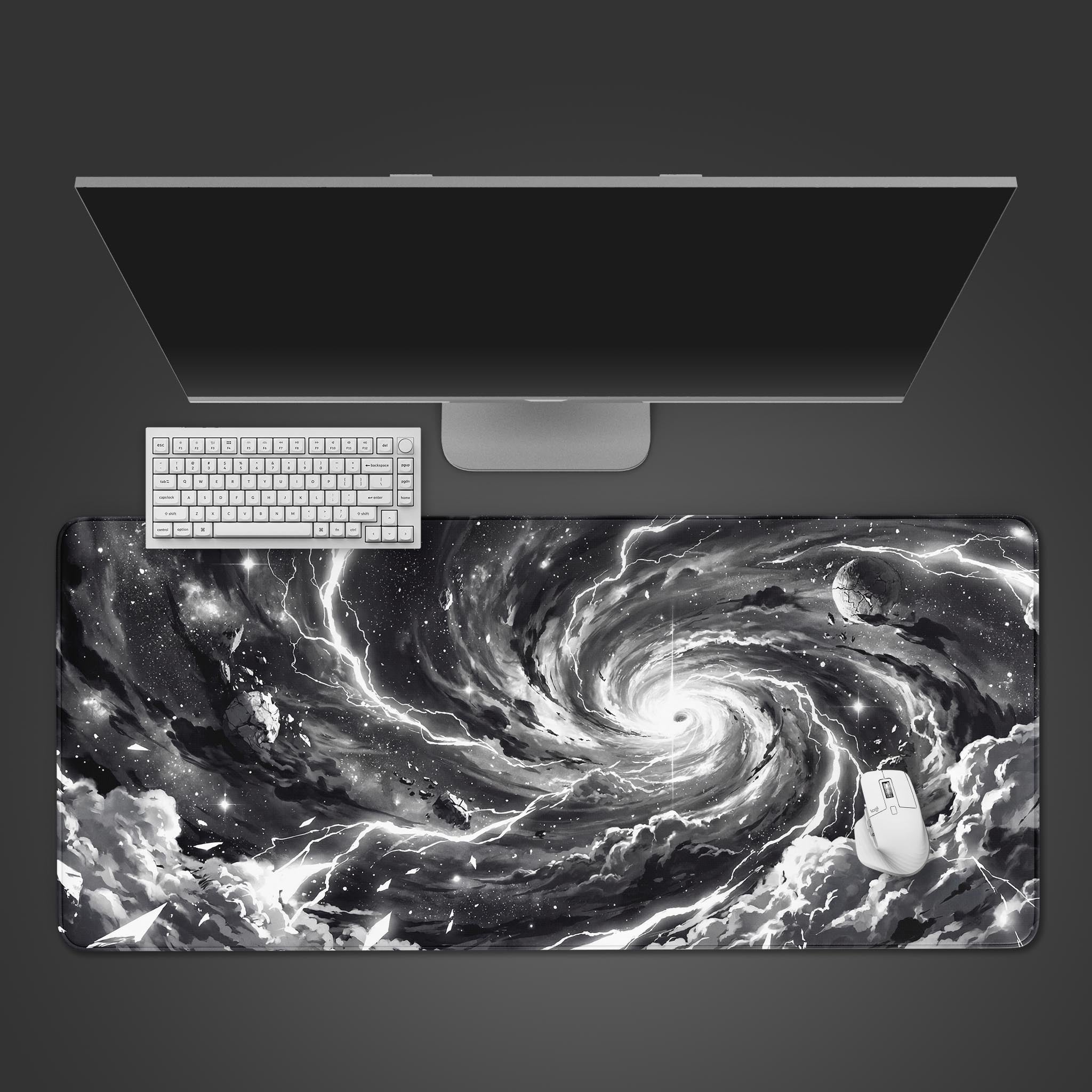 Top-down view of the Singularity Void gaming desk mat, featuring a cosmic black hole design. A white keyboard and mouse are positioned on the mat below a sleek monitor. - Epic Design Pads & Mousepads