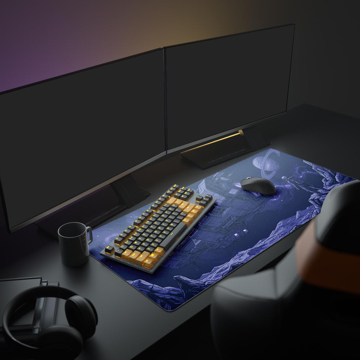 Purple spaceship desk mat on a desk in a dark room with orange-key keyboard, mouse, mug, headphones and two monitors