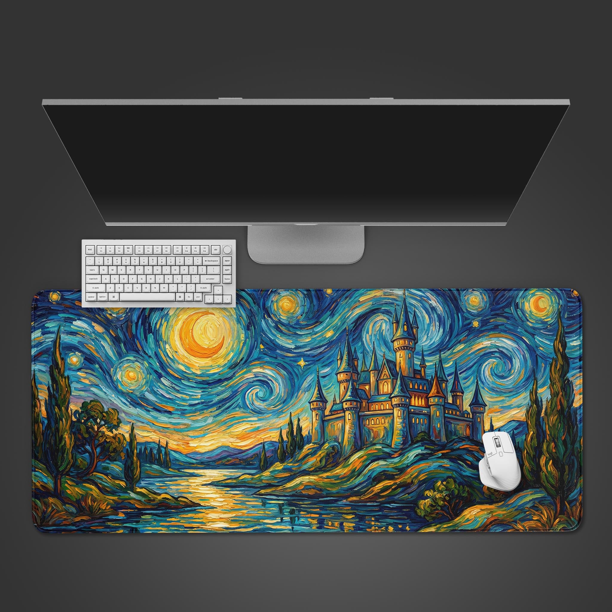 A top-down view of the Starry Castle Night gaming desk mat, showing the fantasy castle design beneath a sleek monitor, keyboard, and white mouse. - Epic Design Pads & Mousepads