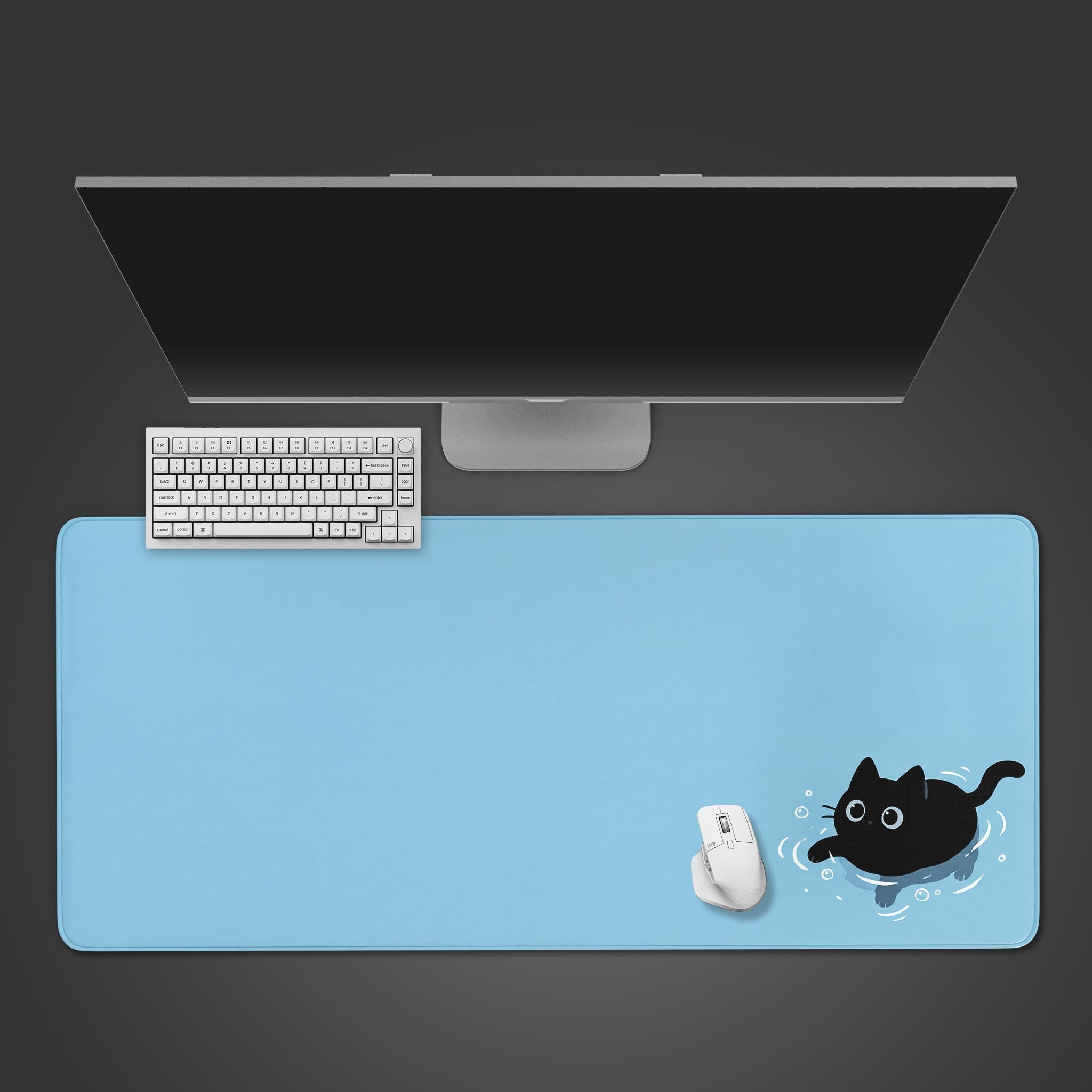 A top-down view of the light blue 'Stay Afloat' cat gaming desk mat, shown with a white keyboard, mouse, and a large monitor on a dark surface. - Epic Design Pads & Mousepads