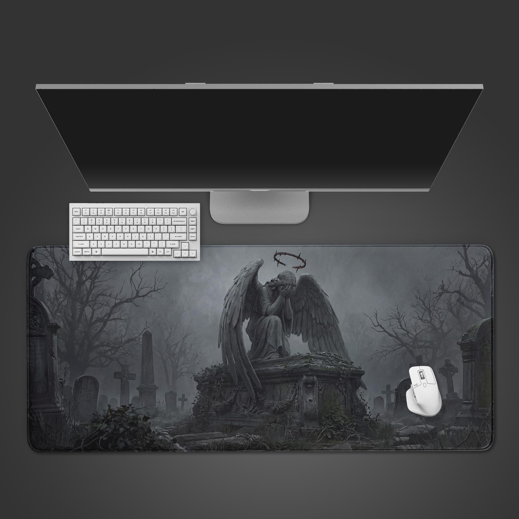 Top-down view of the Stone Seraph gaming desk mat featuring a weeping angel design, shown with a white keyboard and mouse on a dark gray surface. - Epic Design Pads & Mousepads