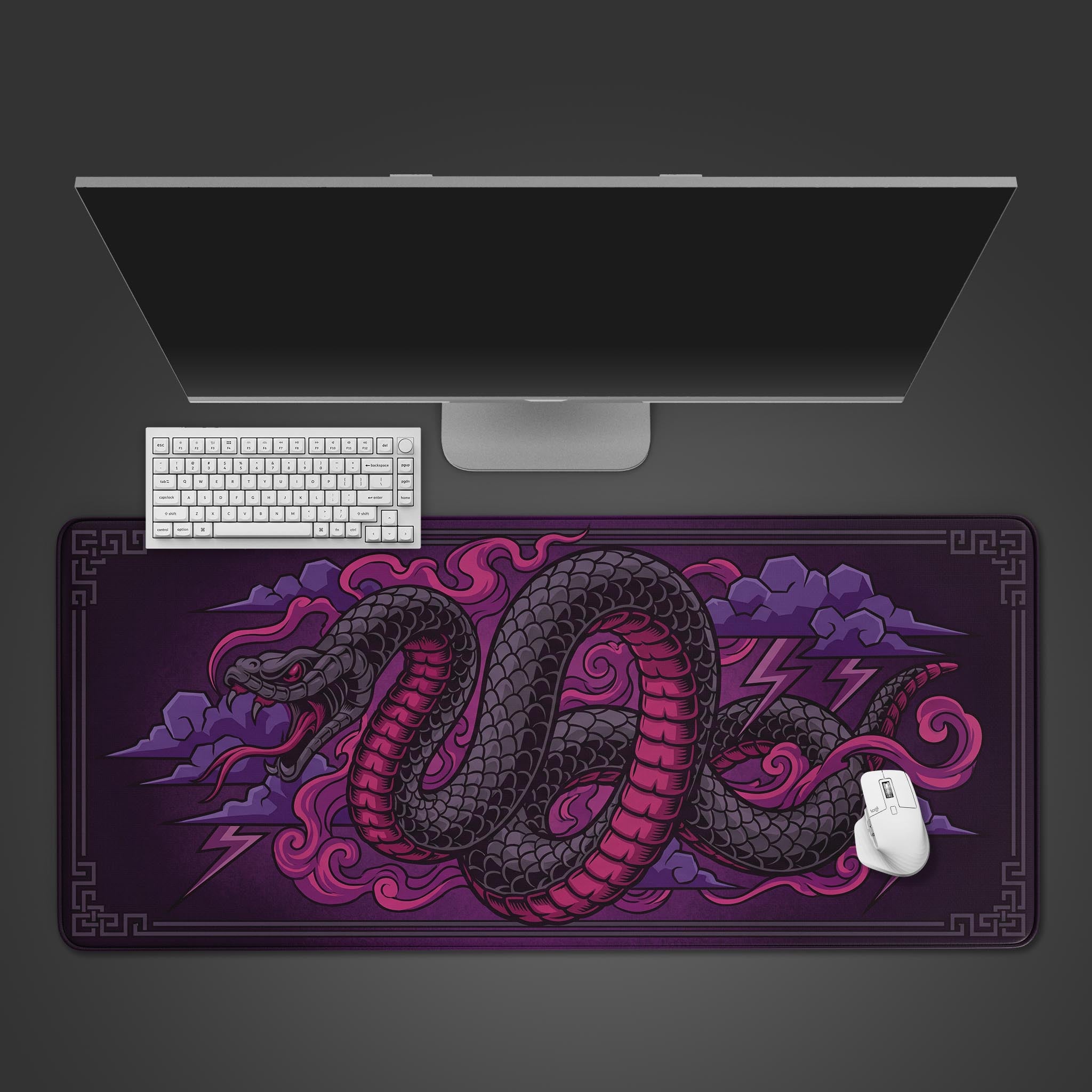 Top-down view of the Storm Serpent gaming desk mat, featuring a mythical purple and black snake design, displayed with a white keyboard, mouse, and monitor on a dark surface. - Epic Design Pads & Mousepads