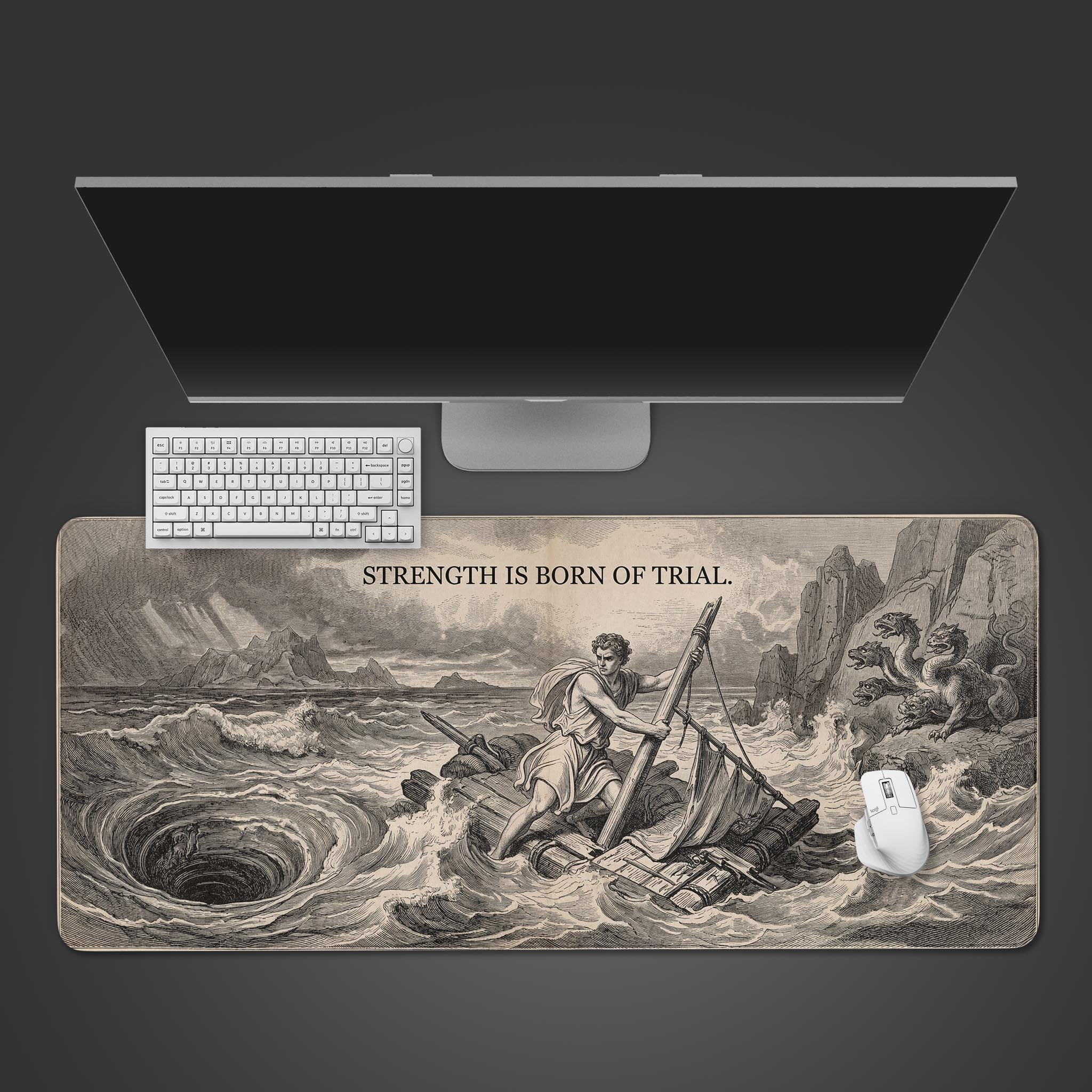 Top-down view of the "Strength is Born of Trial" mythology gaming desk mat on a dark surface, with a white keyboard and mouse, showing the full artwork. - Epic Design Pads & Mousepads