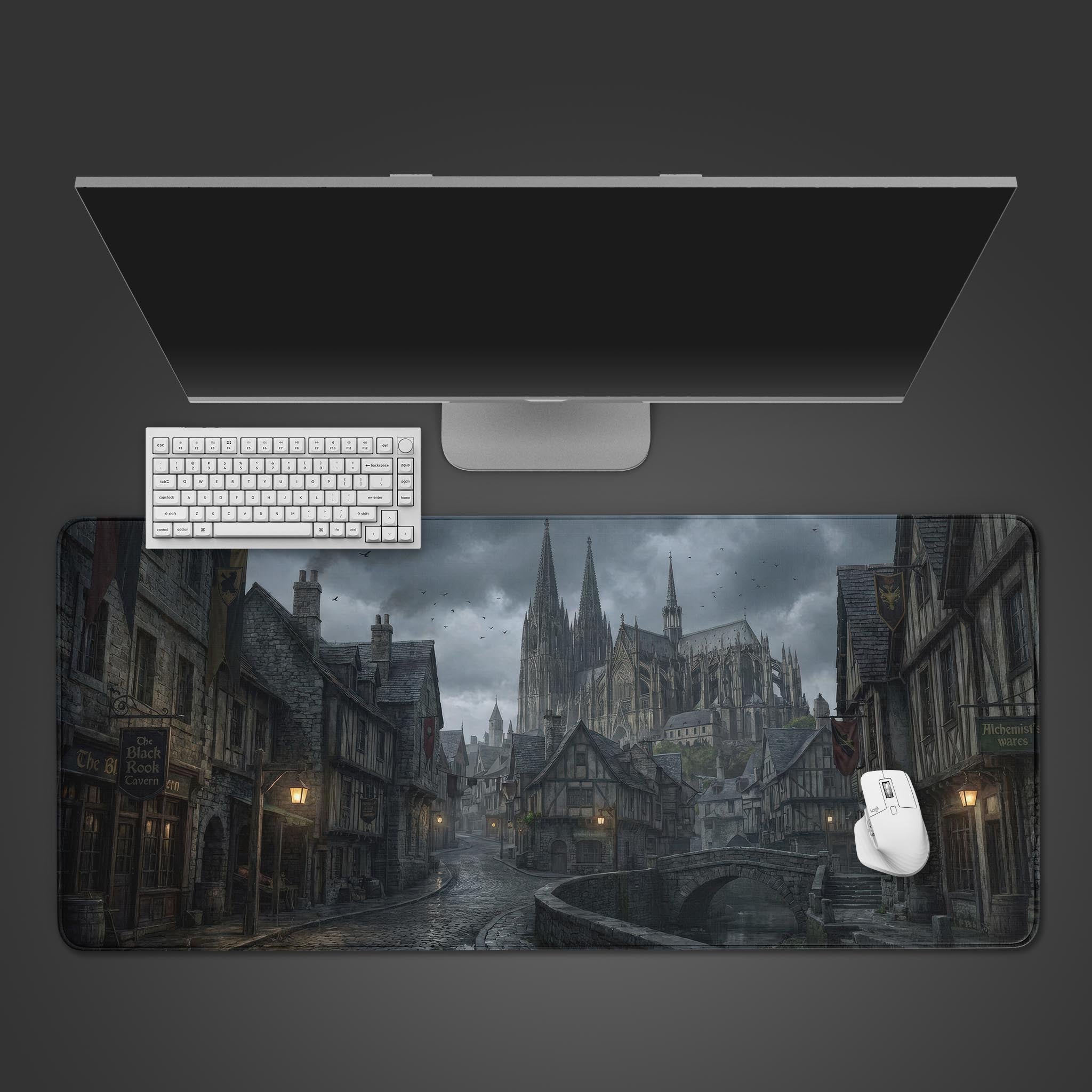 The Tavern Night gaming desk mat seen from above, featuring a dark medieval city street with a keyboard and mouse, set against a grey background. - Epic Design Pads & Mousepads