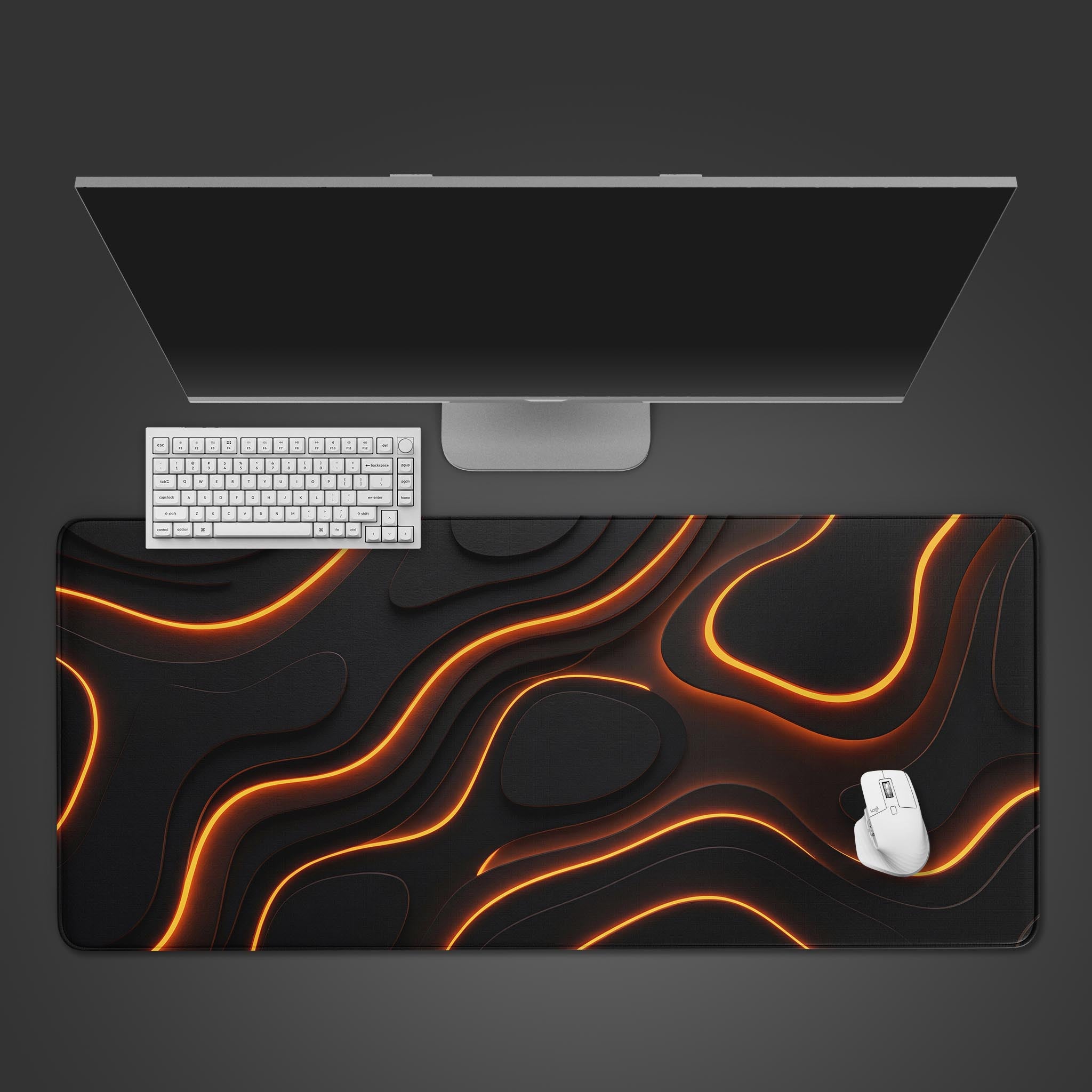 A top-down view of the Tectonic Shift gaming desk mat, featuring an abstract orange and black lava design, with a white keyboard and mouse on top. - Epic Design Pads & Mousepads