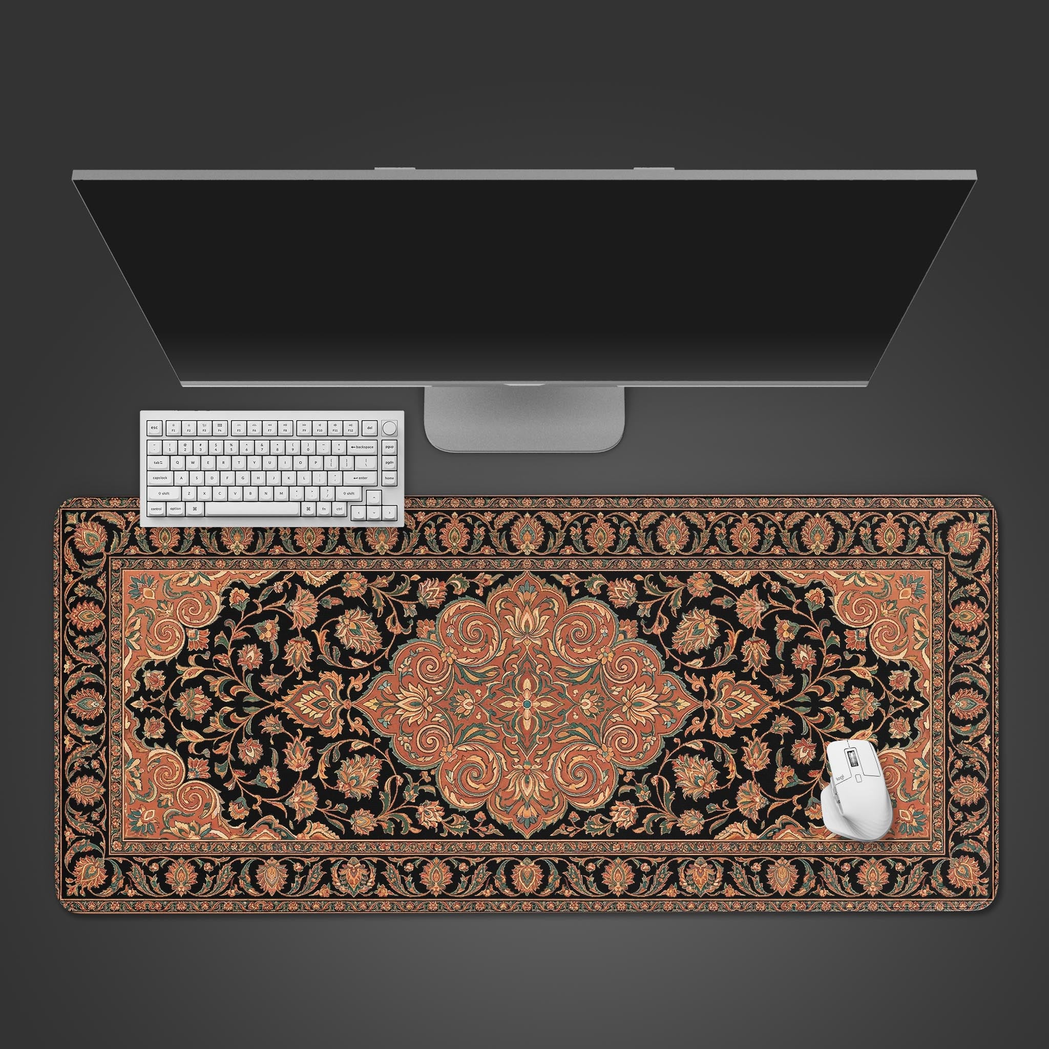 Terracotta Persian rug desk mat with intricate oriental design. Top-down desktop view with a black keyboard and mouse. - Epic Design Pads & Mousepads