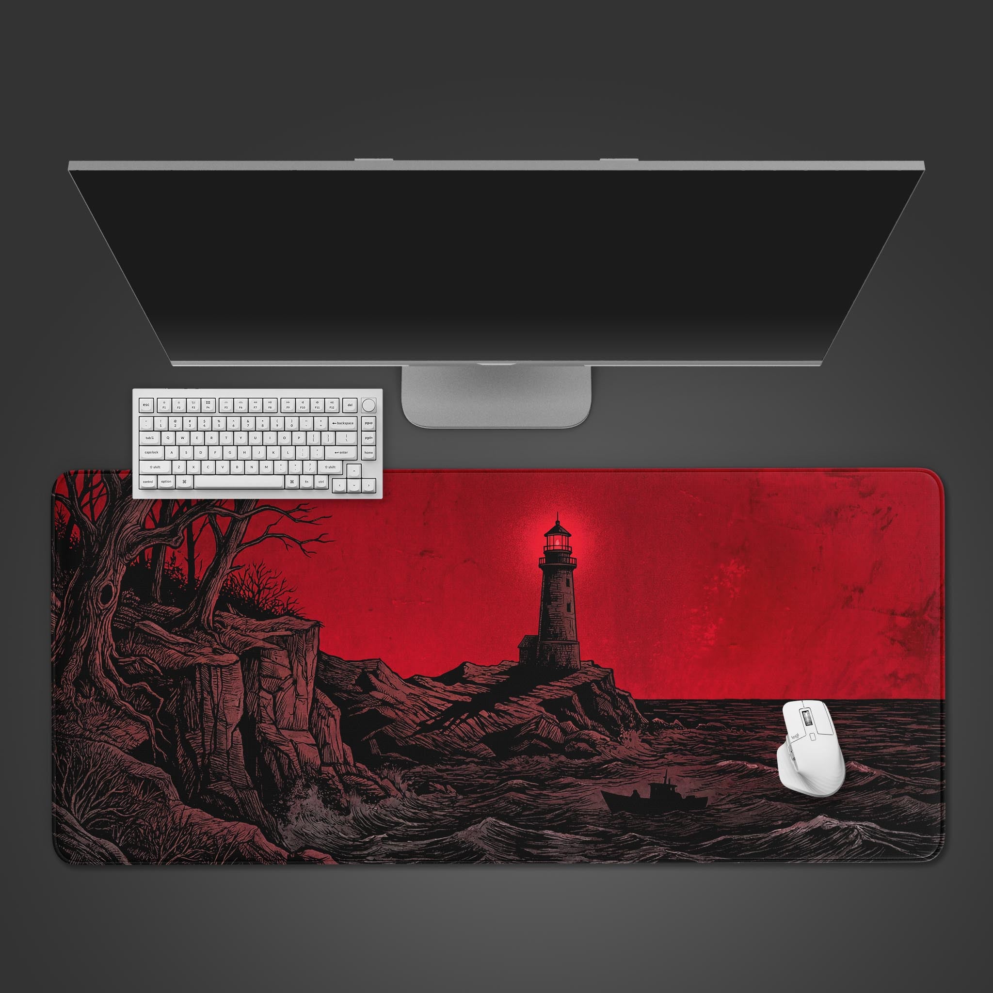 The Night Watch gaming desk mat shown from above, with its red and black lighthouse design, a white keyboard, and a white mouse. - Epic Design Pads & Mousepads