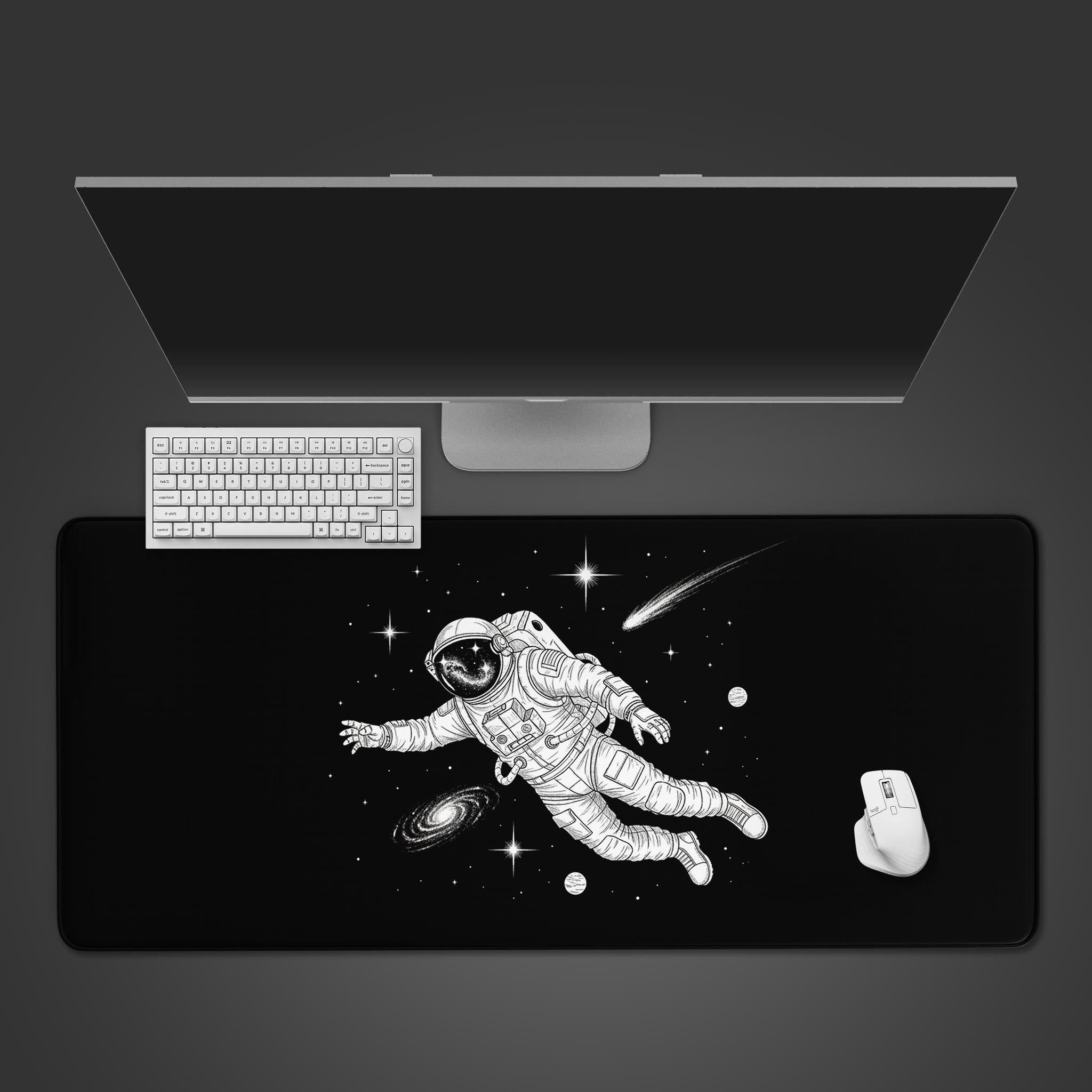 The Void astronaut desk mat with galaxy design, shown from a top-down view on a desk with a white keyboard and mouse. - Epic Design Pads