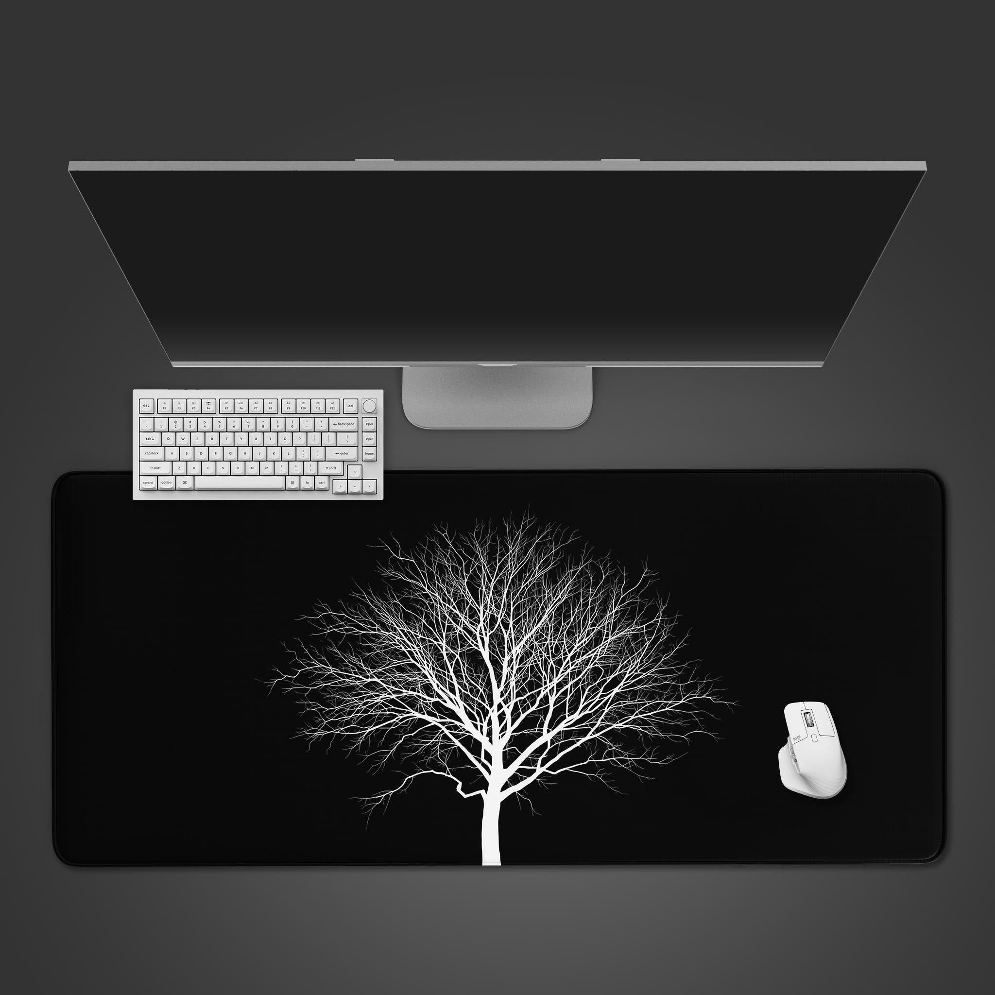 Minimalist desk mat with a white tree design on a black background – top-down desktop view with a keyboard and mouse. - Epic Design Pads