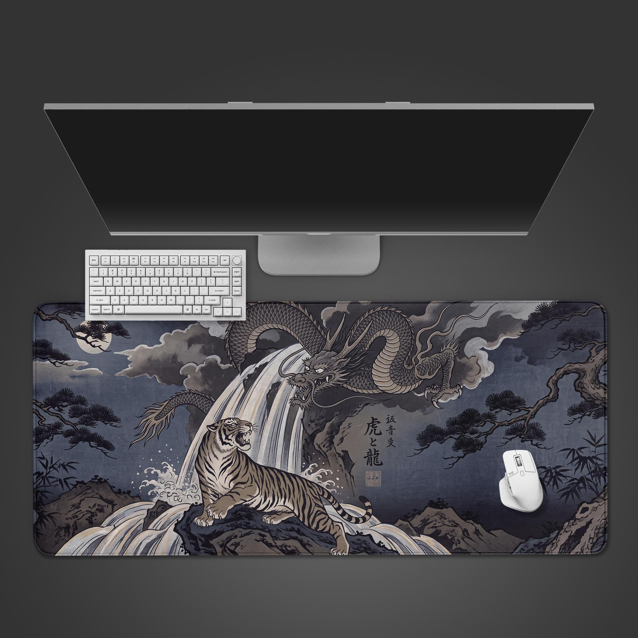 A wide desk mat displaying a traditional Japanese artwork of a tiger and dragon by a cascading waterfall.