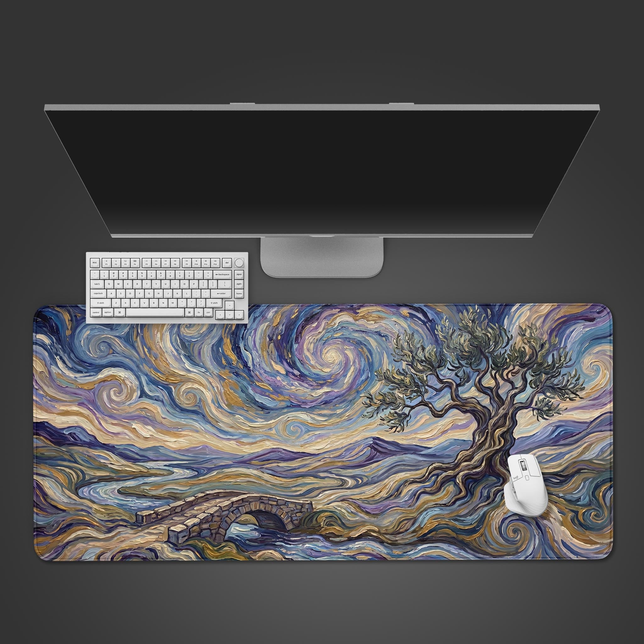 A close up view of an impressionist style desk mat featuring swirling skies, a twisted tree, and a stone bridge in vibrant blues and golds.
