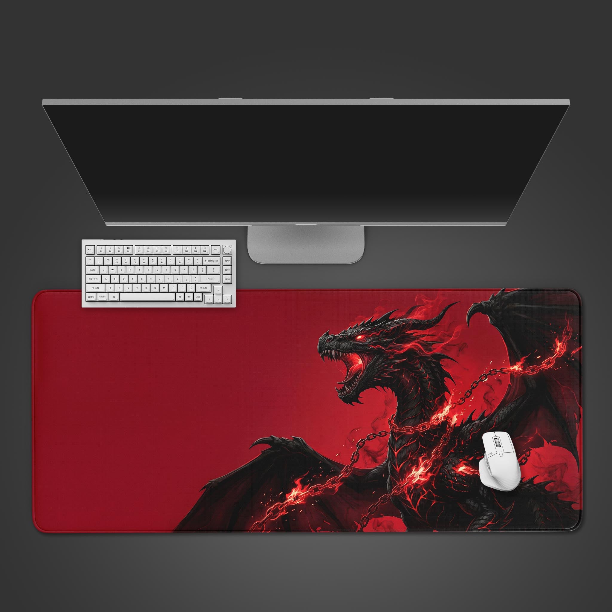 The Unbound Fury gaming desk mat featuring a red and black dragon, shown from above with a white keyboard, mouse, and monitor on a dark background. - Epic Design Pads & Mousepads
