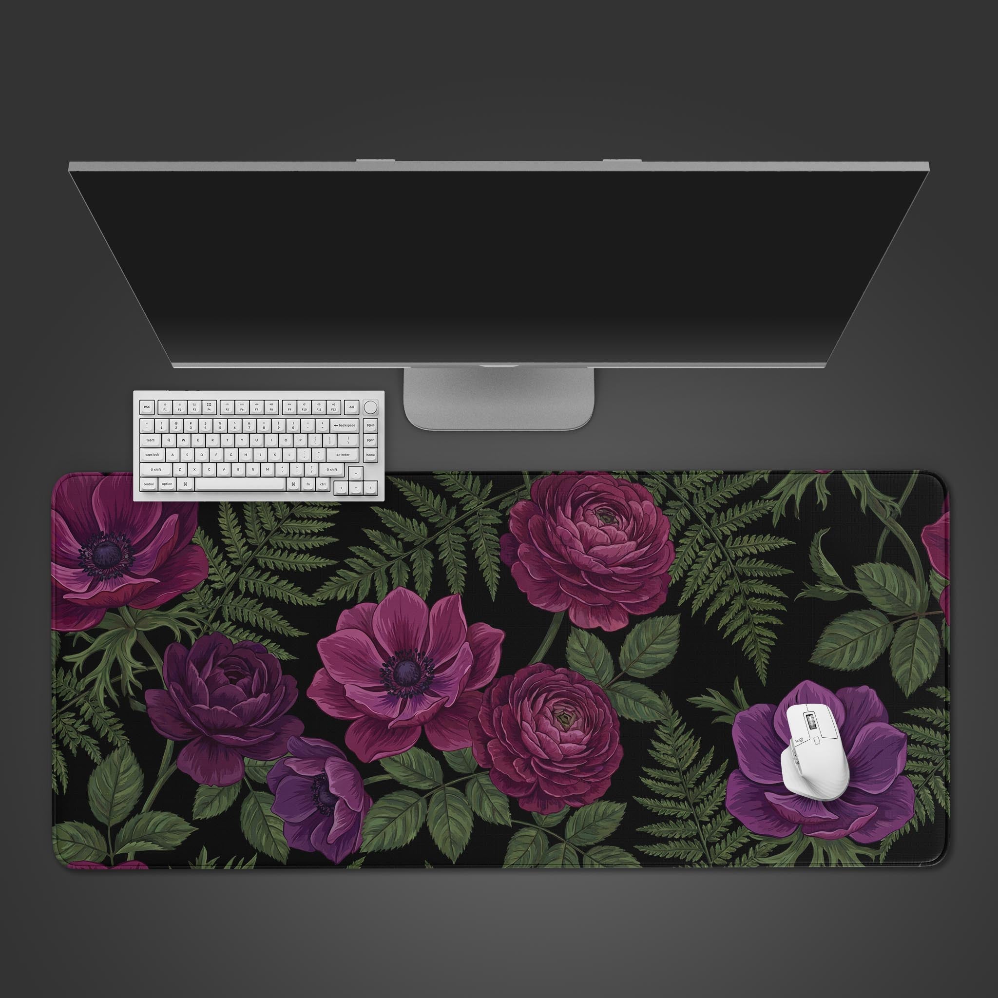 Top-down view of the Velvet Fern Gaming Desk Mat featuring a moody purple floral design, shown with a white keyboard, mouse, and monitor on a dark background. - Epic Design Pads & Mousepads