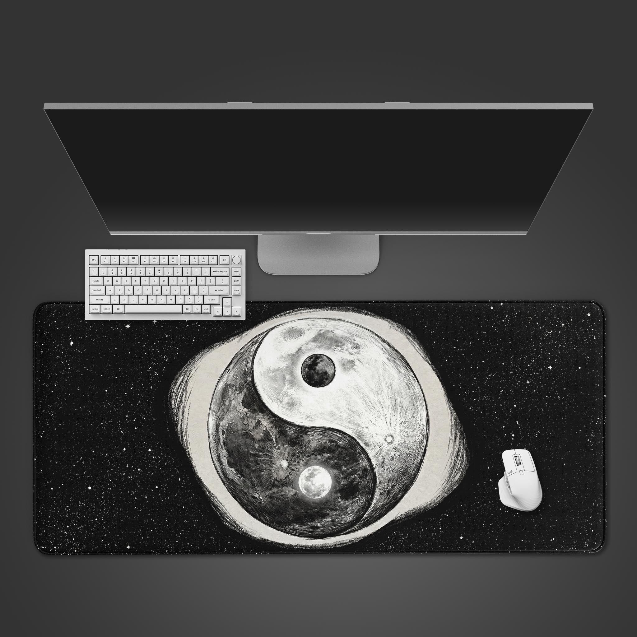 Top-down view of the Cosmic Yin Yang gaming desk mat on a dark desk with a white keyboard and mouse, showcasing the monochrome moon design. - Epic Design Pads & Mousepads