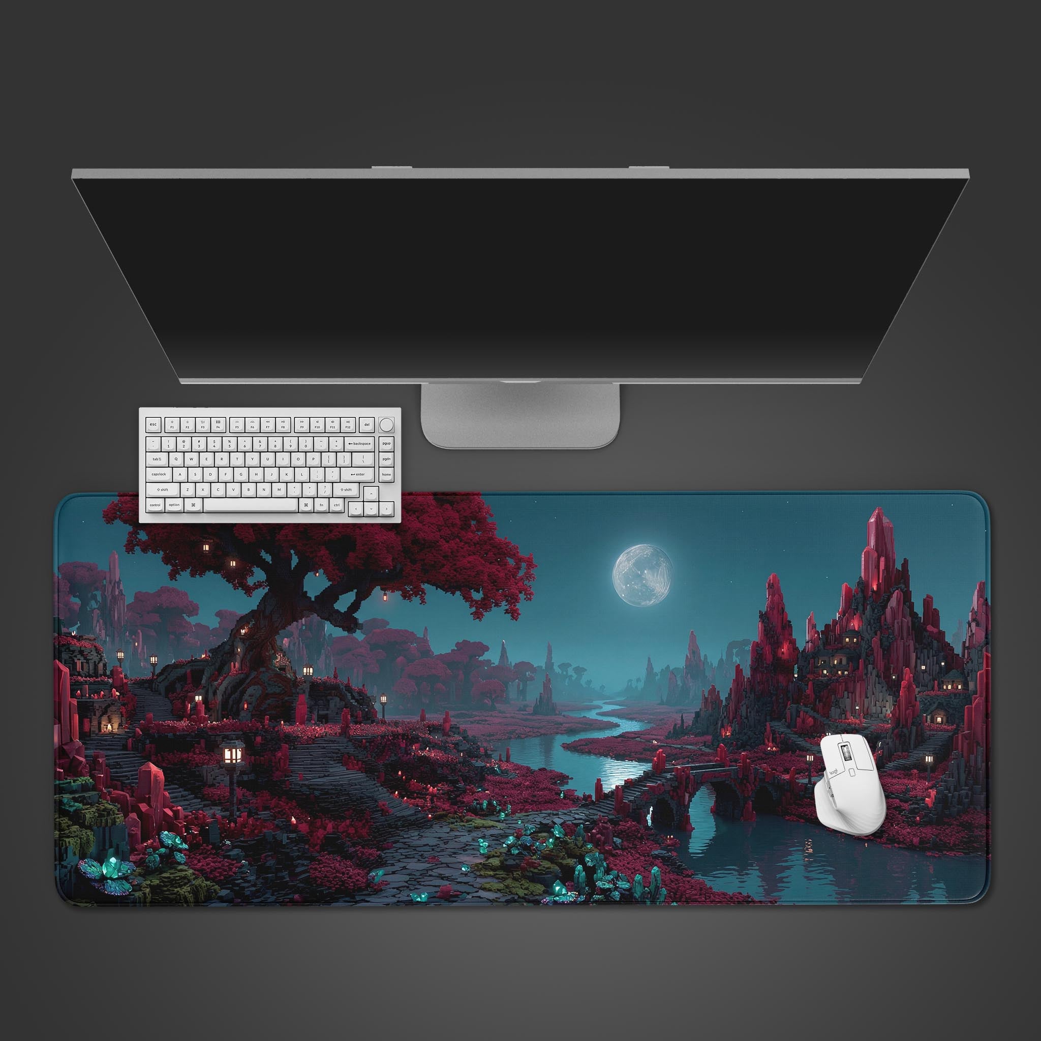 Top-down view of the Voxel Valley gaming desk mat, featuring a surreal crimson and teal landscape, shown with a white keyboard, mouse, and a large monitor on a clean desk setup. - Epic Design Pads & Mousepads