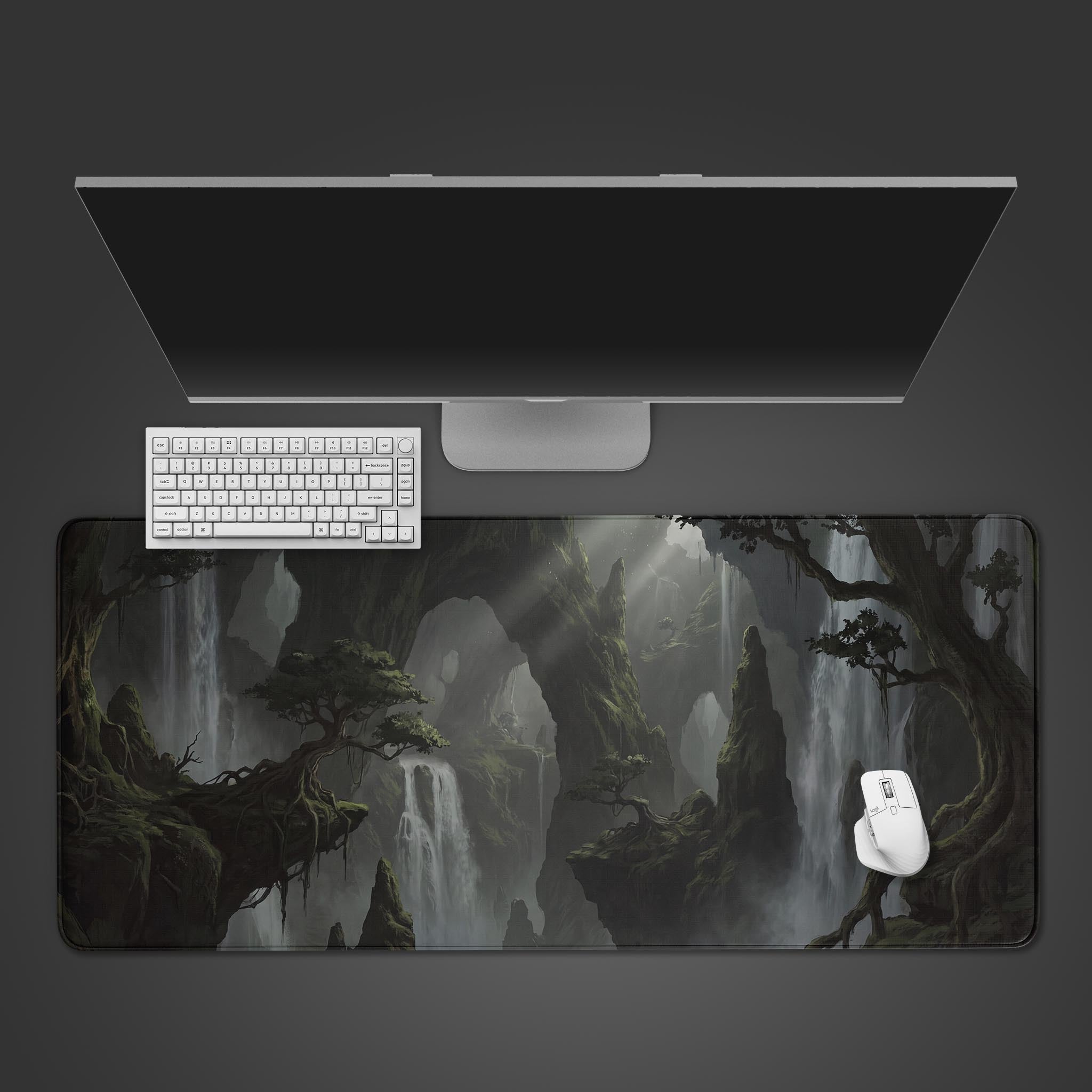 Misty fantasy landscape desk mat featuring towering mossy cliffs and cascading waterfalls