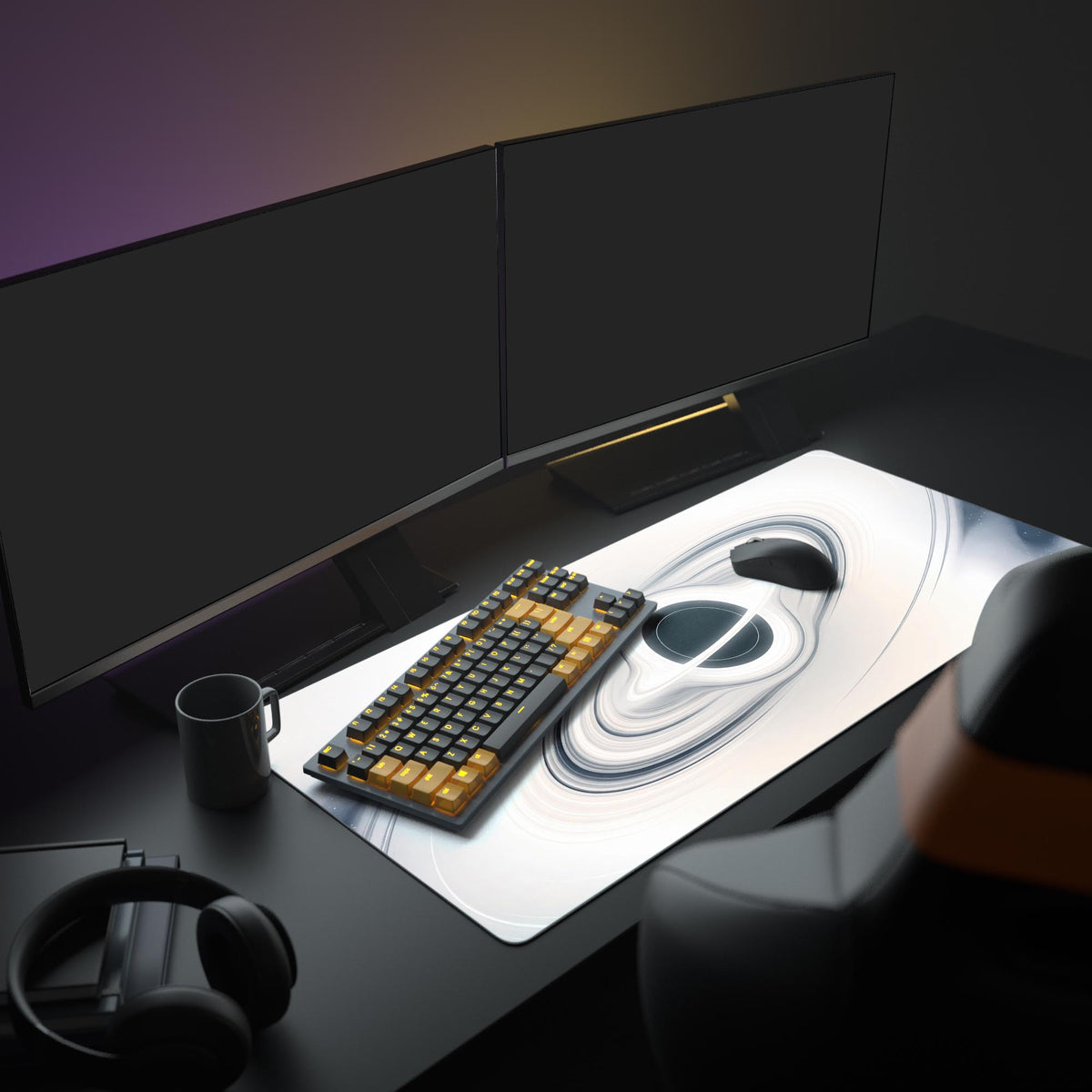 Ivory black hole desk mat on a dark desk with two monitors, black and orange keyboard, black mouse, mug and headphones