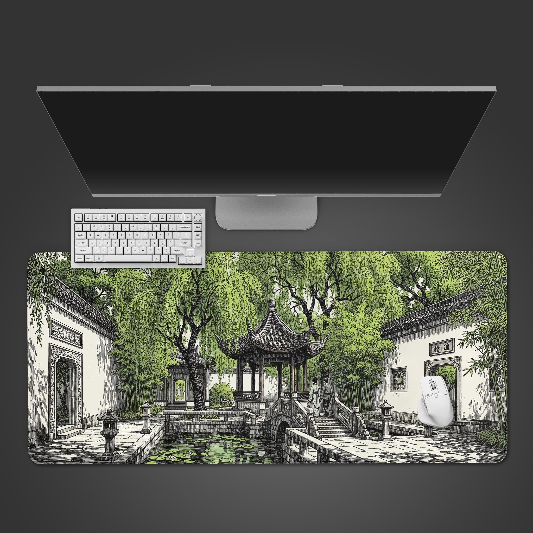 Top-down view of the Willow Pavilion gaming desk mat, featuring a Chinese garden design, shown with a white keyboard and monitor on a dark surface. - Epic Design Pads & Mousepads