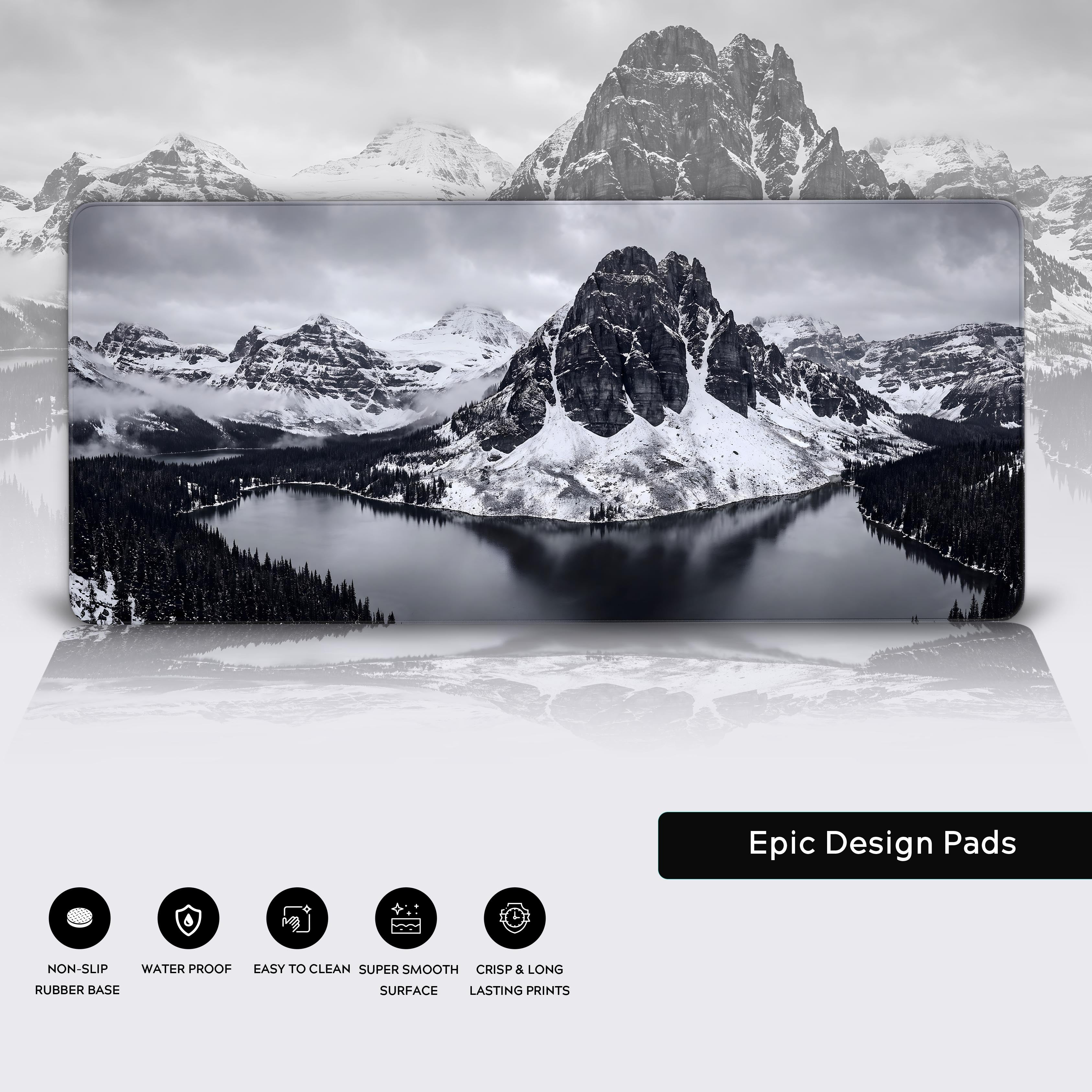 Product view of a black and white mountain landscape desk mat hovering above a glossy white surface.