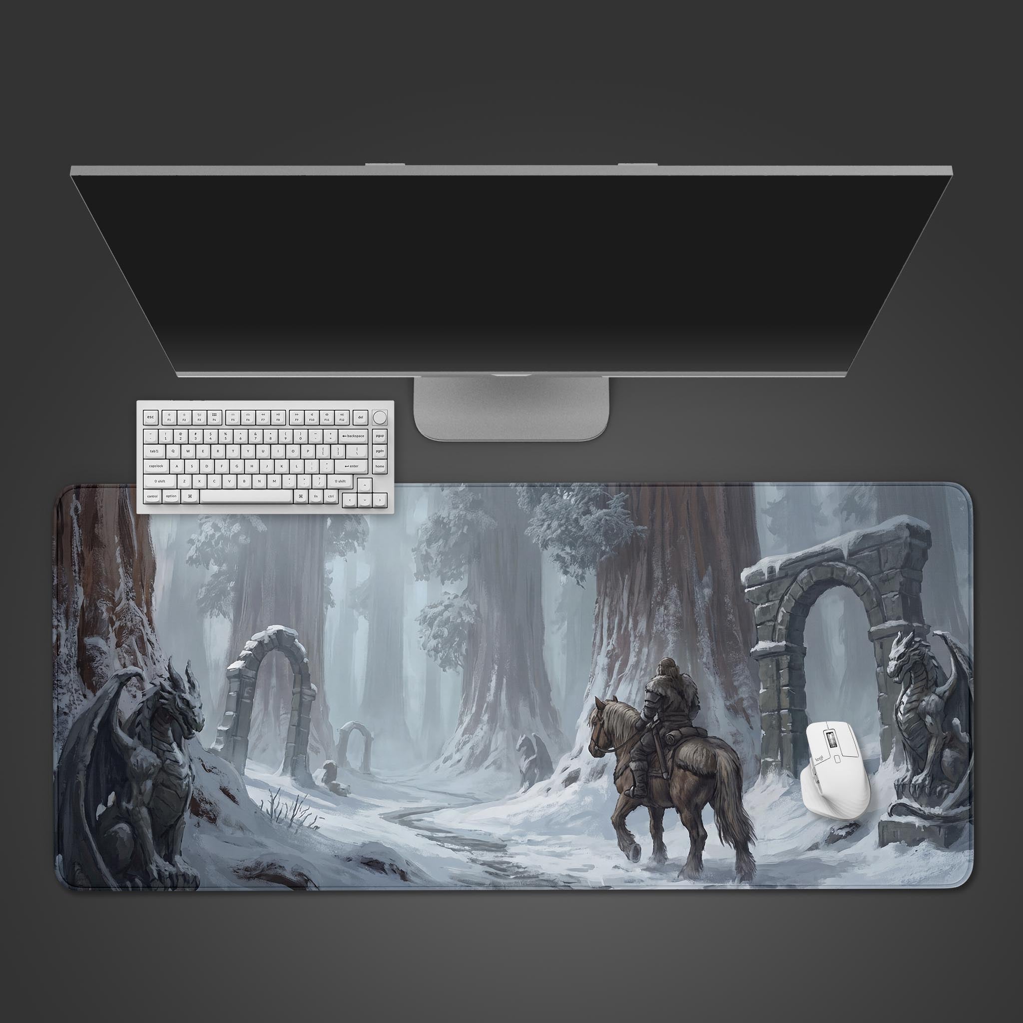 A desk mat featuring a lone rider on horseback navigating a snowy forest path with ancient stone archways and dragon statues.