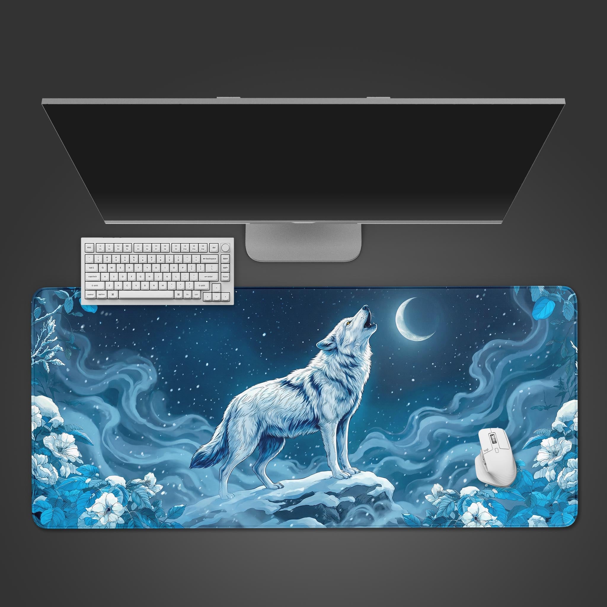 Winter's Howl wolf desk mat with blue floral design. Top-down view on a desk with a white keyboard and mouse, showing ample space. - Epic Design Pads & Mousepads